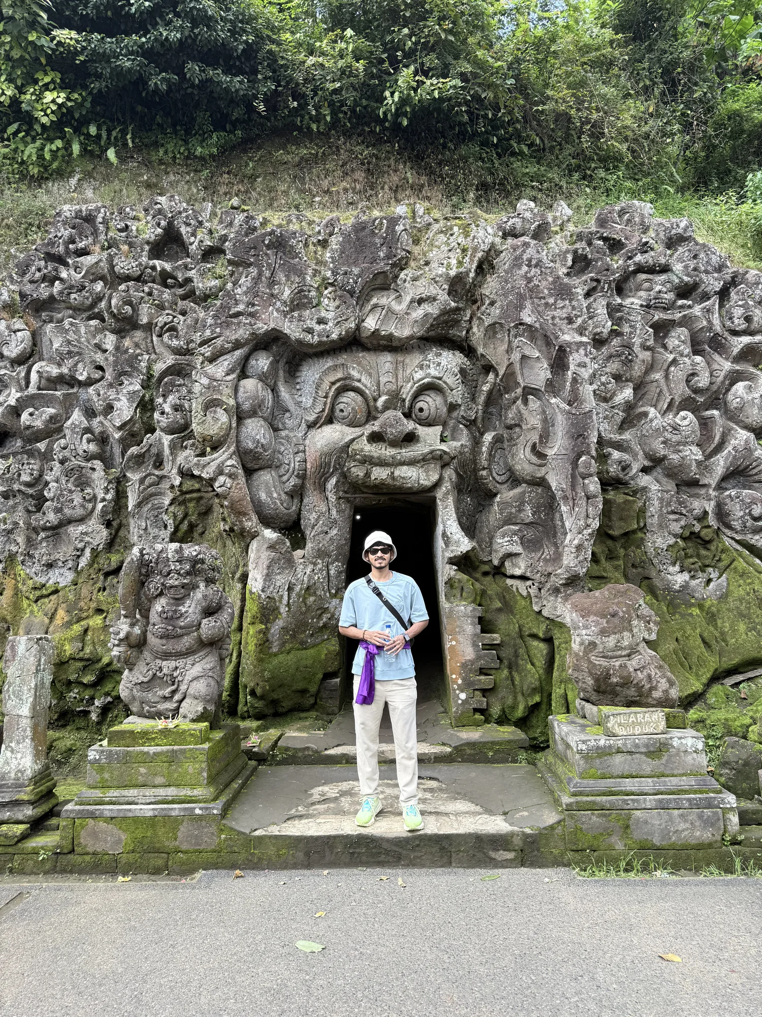 Carved stone cave entrance at a temple near Ubud